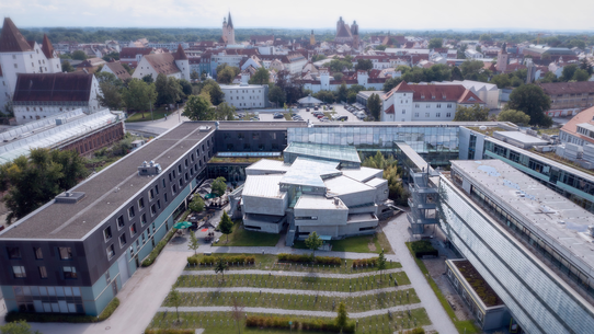 Drohnenaufnahme vom Campus der THI von schräg oben mit der Stadt Ingolstadt im Hintergrund