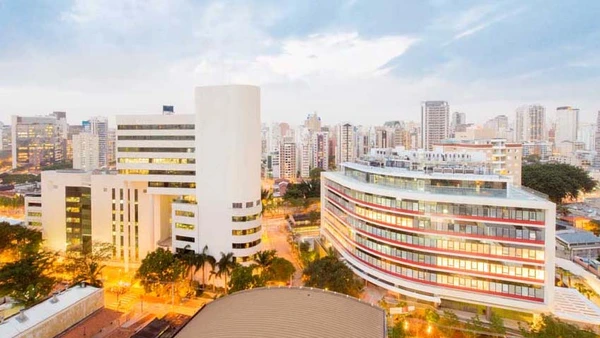 Insper University amid the brightly lit skyline of Sao Paulo.