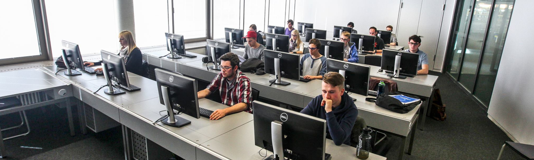 Some students sit in the PC pool of the library