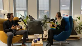 A man and a woman in studio conversation
