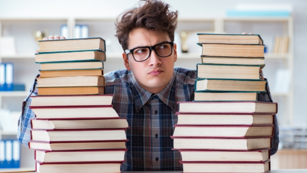 Illustration of a doctoral student between stacked books