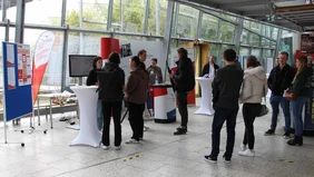 A group of prospective students at the Business School stand.
