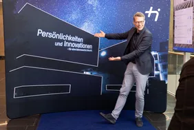 Stattsminister Blume vor einer Leinwand mit der Architektur der THI