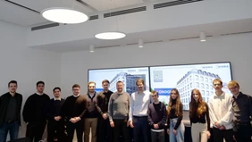 Group photo in front of two screens