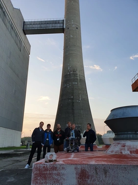 Participants of the THI team stand in front of the nuclear power plant