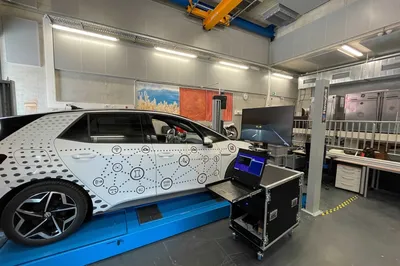Fahrzeuig auf Teststand in Labor; davor Bildschirme udn Laptopn mit VR-Umgebung und Testdaten